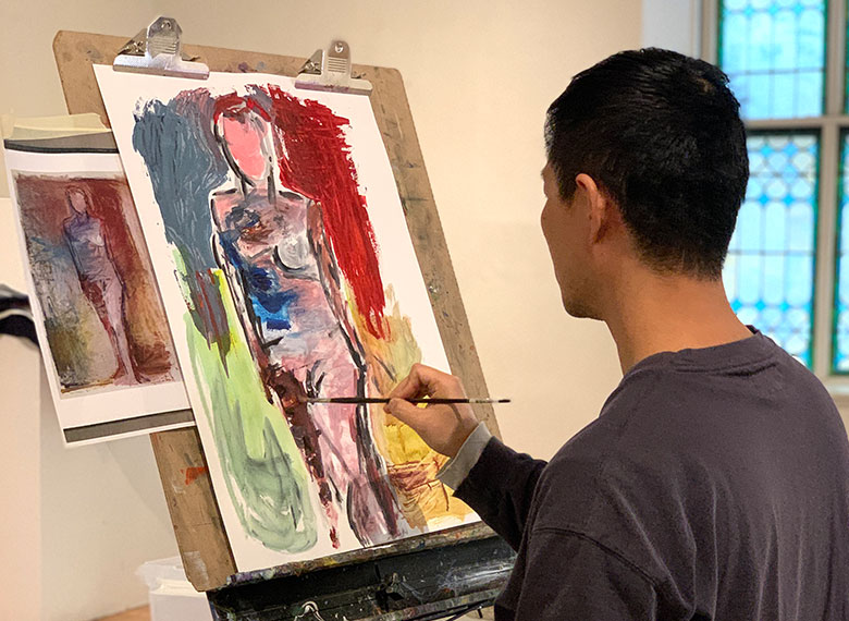 an adult student paints