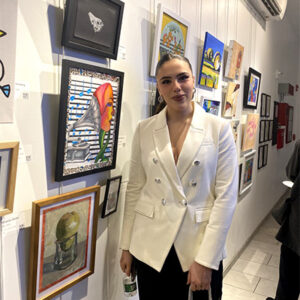 A woman stands in our New Art Corridor Gallery during an opening reception
