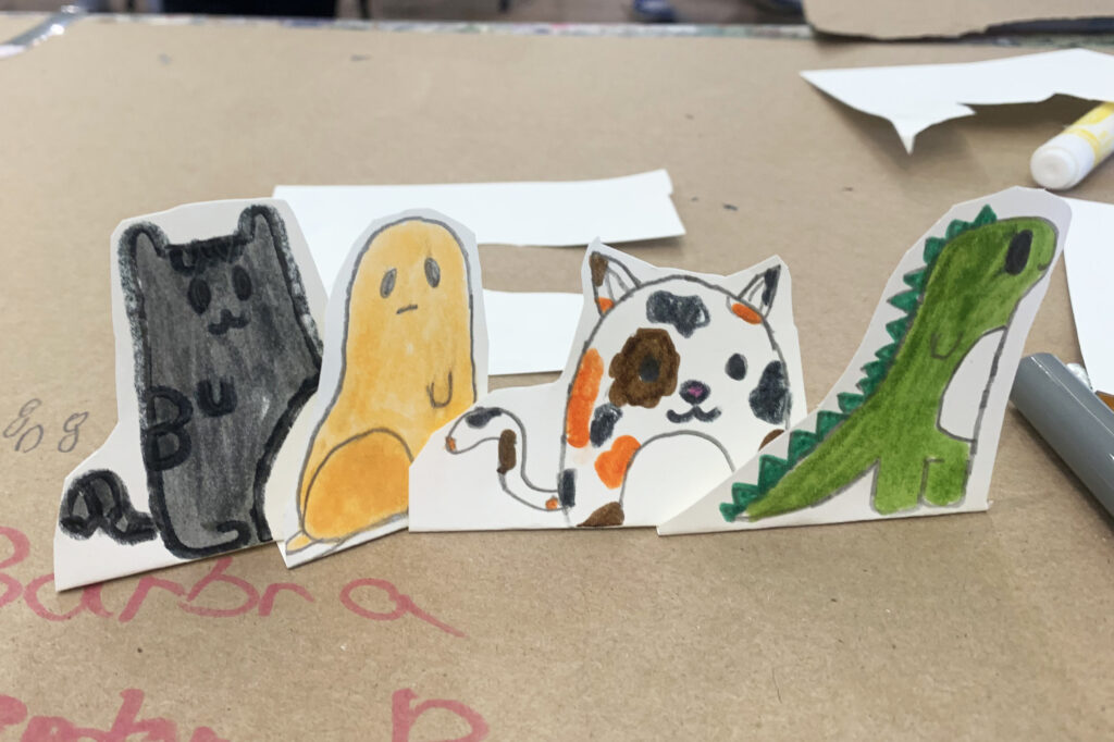 Four animal hand-drawn game pieces.